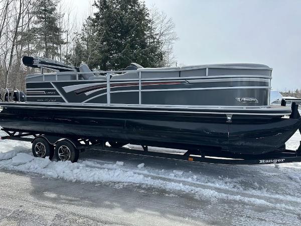 Ranger 243C 2021 Ranger 243C pontoon boat on a trailer in a snowy setting.