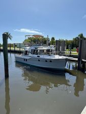Ranger Tugs R-29 CB 2024 Ranger Tugs R-29 CB boat docked in a sunny marina setting.