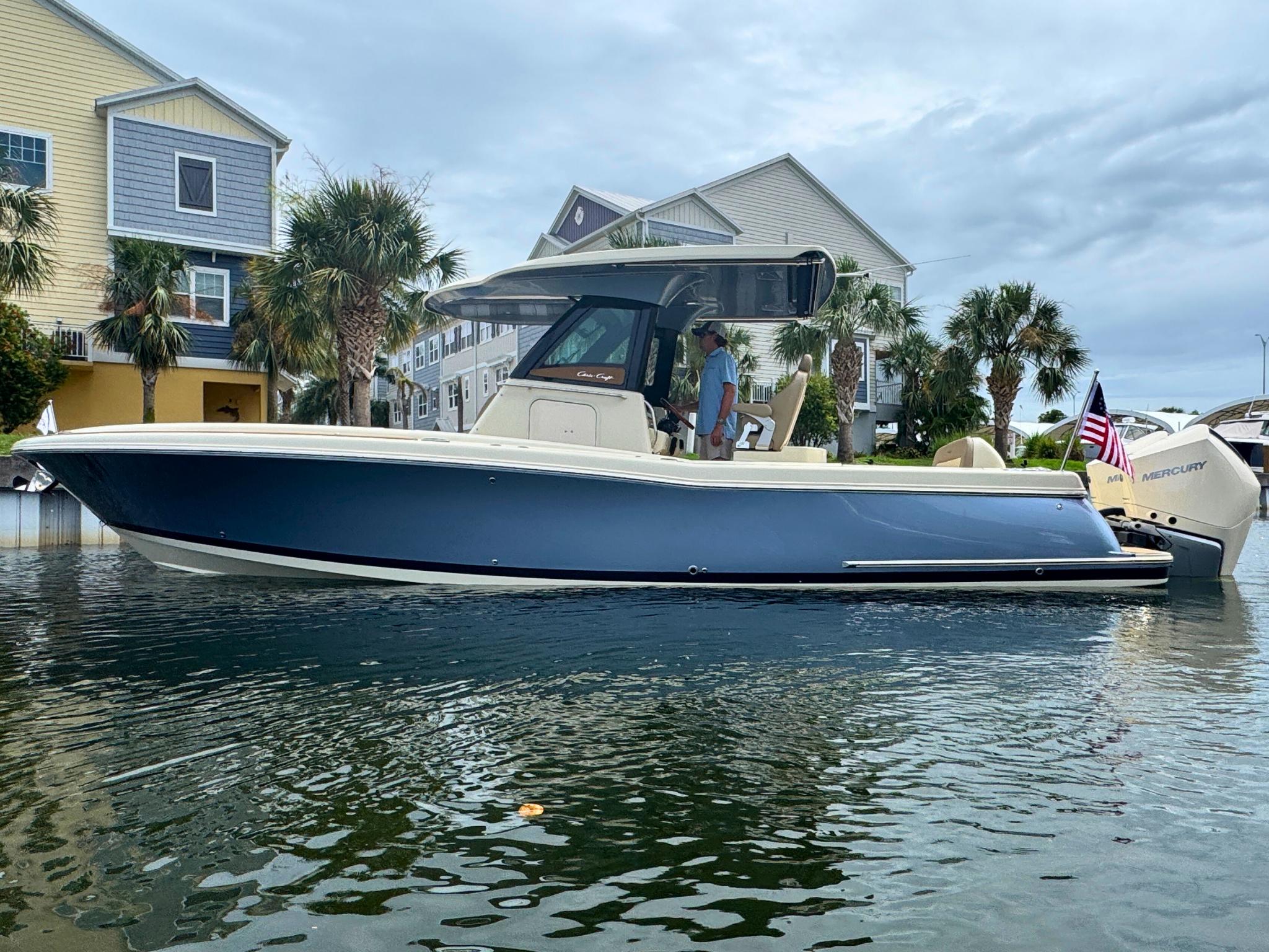 Chris-Craft Catalina 30 2025 Chris-Craft Catalina 30 boat docked near waterfront homes, featuring sleek design and modern amenities.