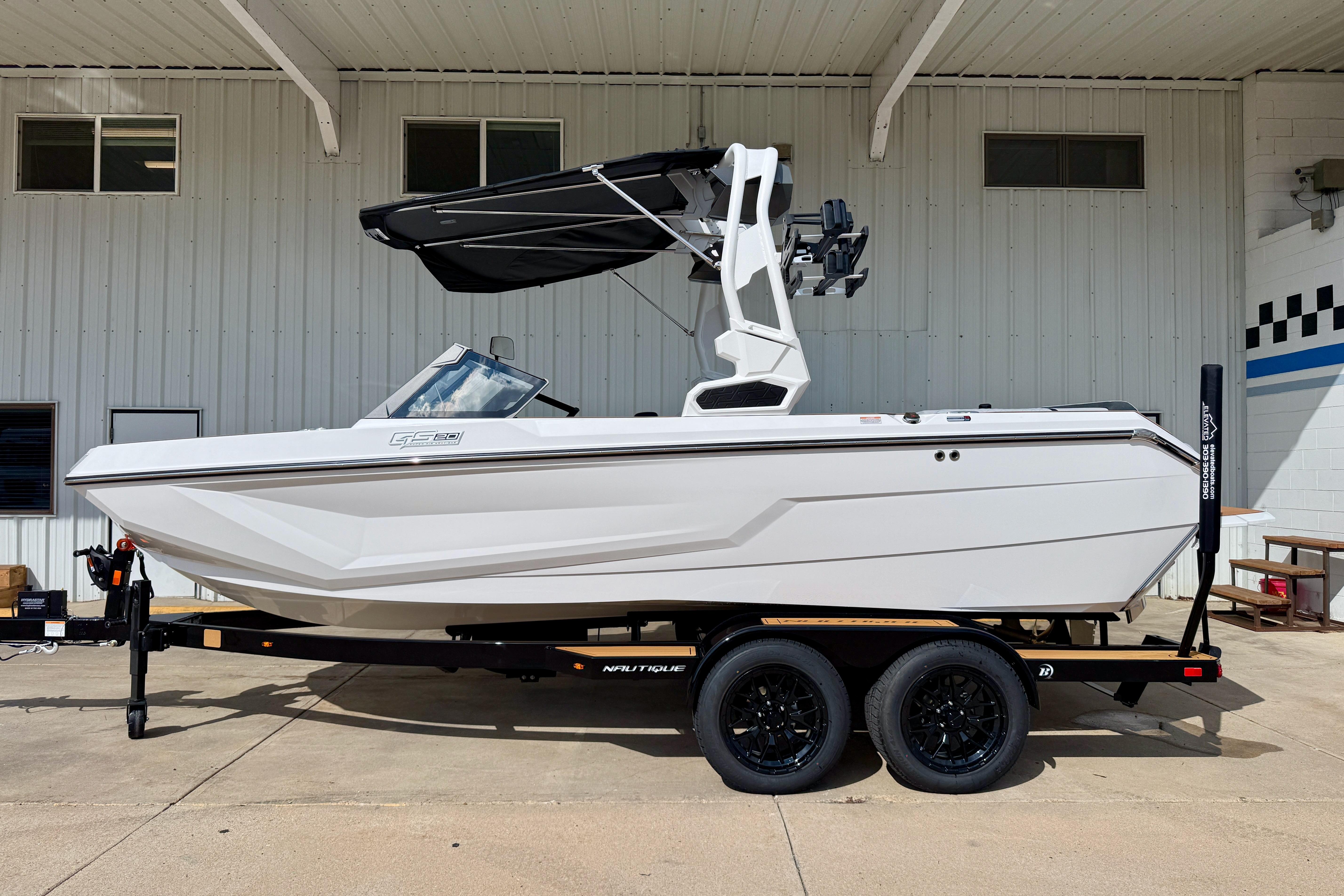 Nautique Super Air Nautique GS20 2026 Nautique Super Air Nautique GS20 boat on trailer, parked outside a building.