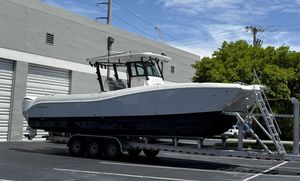 World Cat 325 CC 2023 World Cat 325 CC boat on trailer, parked near industrial building.