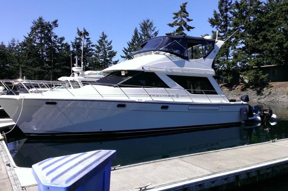 Bayliner 3988 Command Bridge Motoryacht 1999 Bayliner 3988 Command Bridge Motoryacht docked, surrounded by trees and clear sky.