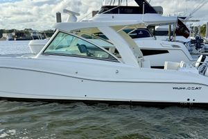 World Cat 320 DC 2016 World Cat 320 DC boat docked in marina, side view.