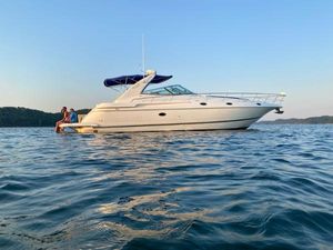 Cruisers Yachts 4270 Express 2000 Cruisers Yachts 4270 Express on calm water at sunset.