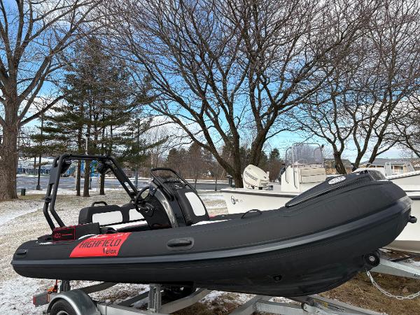 Highfield Velox 420 2025 Highfield Velox 420 inflatable boat on trailer, parked outdoors in winter setting.