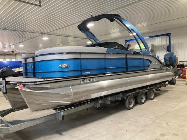 Manitou 25 Legacy LT RFXW 2019 Manitou 25 Legacy LT RFXW pontoon boat on trailer in indoor storage.