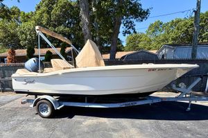 Scout 195 Sportfish 2023 Scout 195 Sportfish boat on trailer, parked outdoors.
