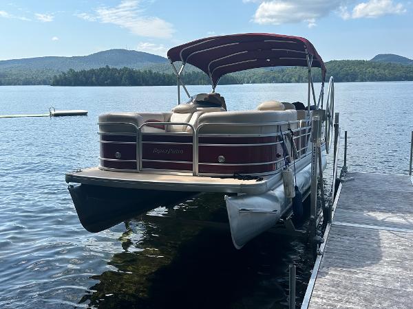 Godfrey 2086 Godfrey 2086 pontoon boat docked on a serene lake, 2012 model.