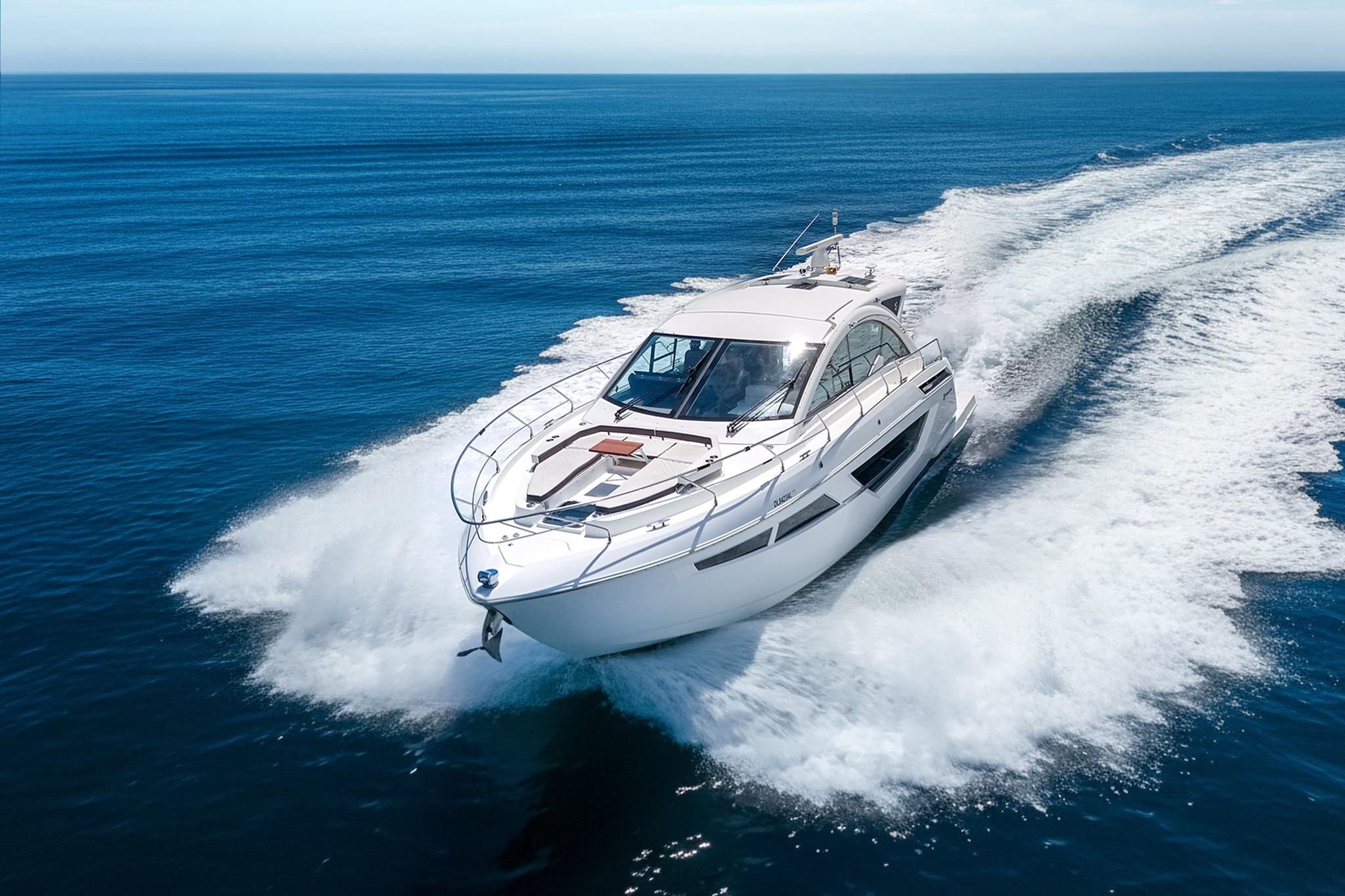 Cruisers Yachts 50 Cantius 2018 Cruisers Yachts 50 Cantius cruising on open ocean, creating dynamic water spray.
