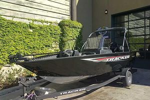 Tracker Pro Guide V-175 WT 2026 Tracker Pro Guide V-175 WT boat on trailer, parked outdoors near ivy-covered wall.