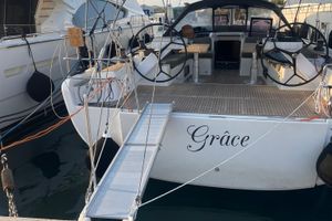 Hanse 575 2013 Hanse 575 yacht "Grâce" docked with open cockpit and dual steering wheels.
