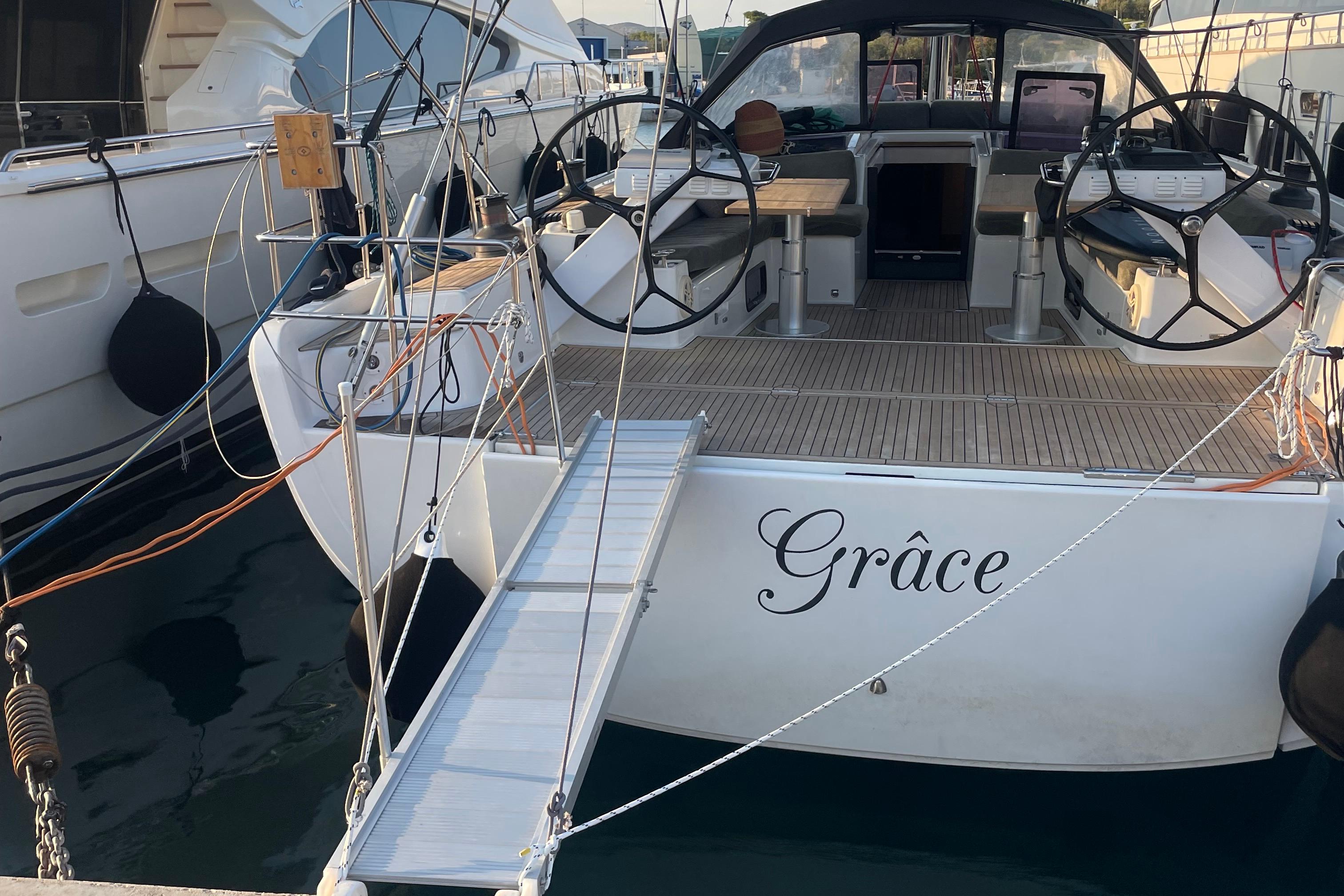 Hanse 575 2013 Hanse 575 yacht "Grâce" docked with open cockpit and dual steering wheels.
