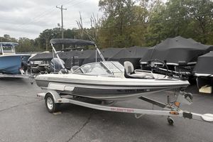 Skeeter SL180 2008 Skeeter SL180 boat on trailer, parked outdoors with other covered boats.