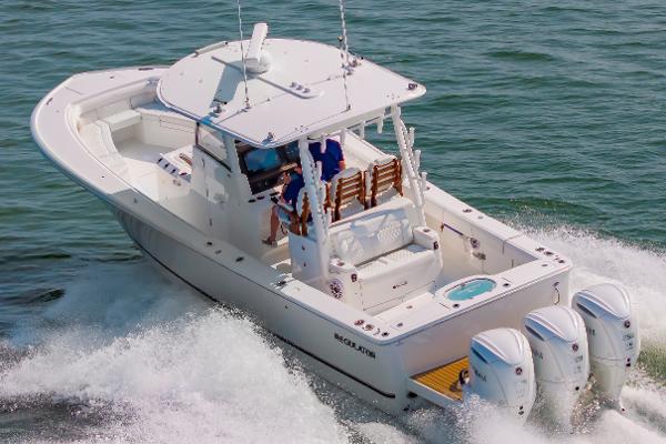Regulator 35 2025 Regulator 35 boat cruising on water with four powerful outboard engines.