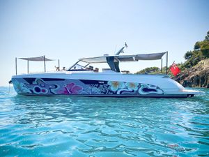 Franchini T63 Franchini T63 2021 yacht with vibrant floral design, anchored in clear blue water.