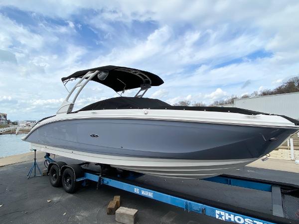 Sea Ray SDX 290 2021 Sea Ray SDX 290 boat on trailer under cloudy sky.