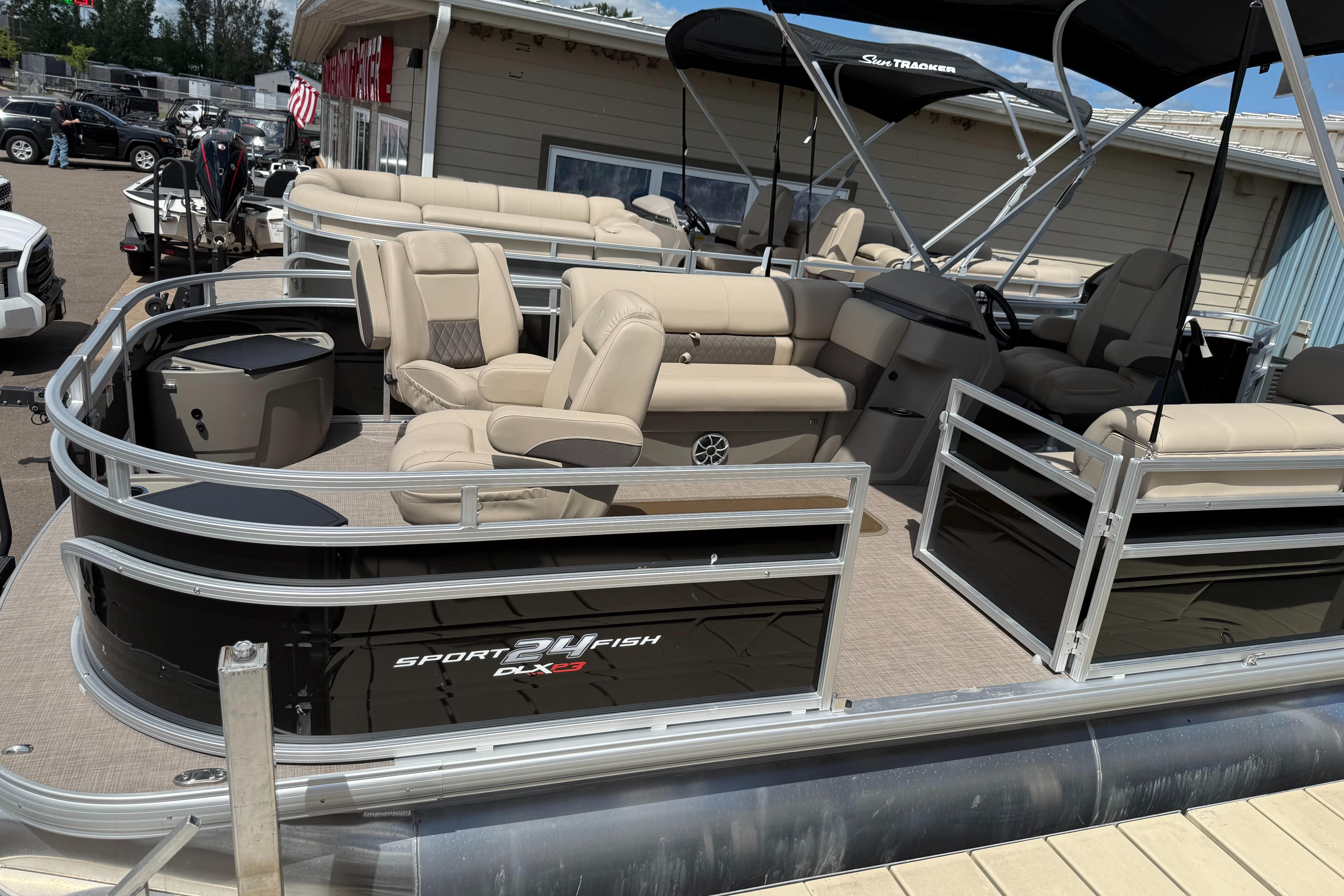 Sun Tracker Sportfish 24 XP3 2024 Sun Tracker Sportfish 24 XP3 pontoon boat with beige seating and black exterior.