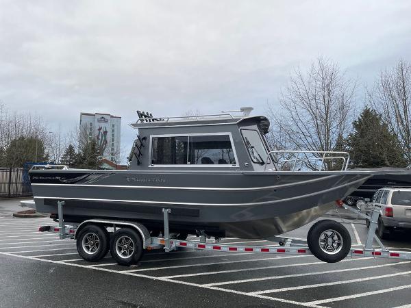 Spartan Maximus 240 2024 Spartan Maximus 240 boat on a trailer in a parking lot.