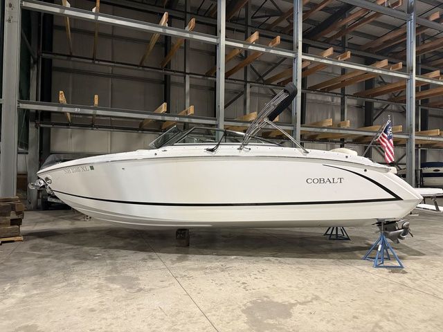 Cobalt R5 2017 Cobalt R5 boat in storage, white exterior, American flag, indoor warehouse setting.