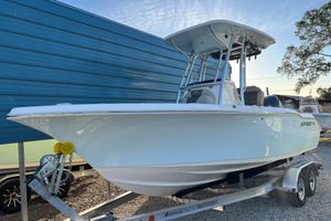 Key West 219 FS 2026 Key West 219 FS boat on trailer, parked outdoors near blue building.