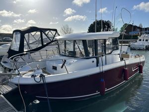 Jeanneau Merry Fisher 755 Marlin 2013 Jeanneau Merry Fisher 755 Marlin boat docked in a marina under a cloudy sky.