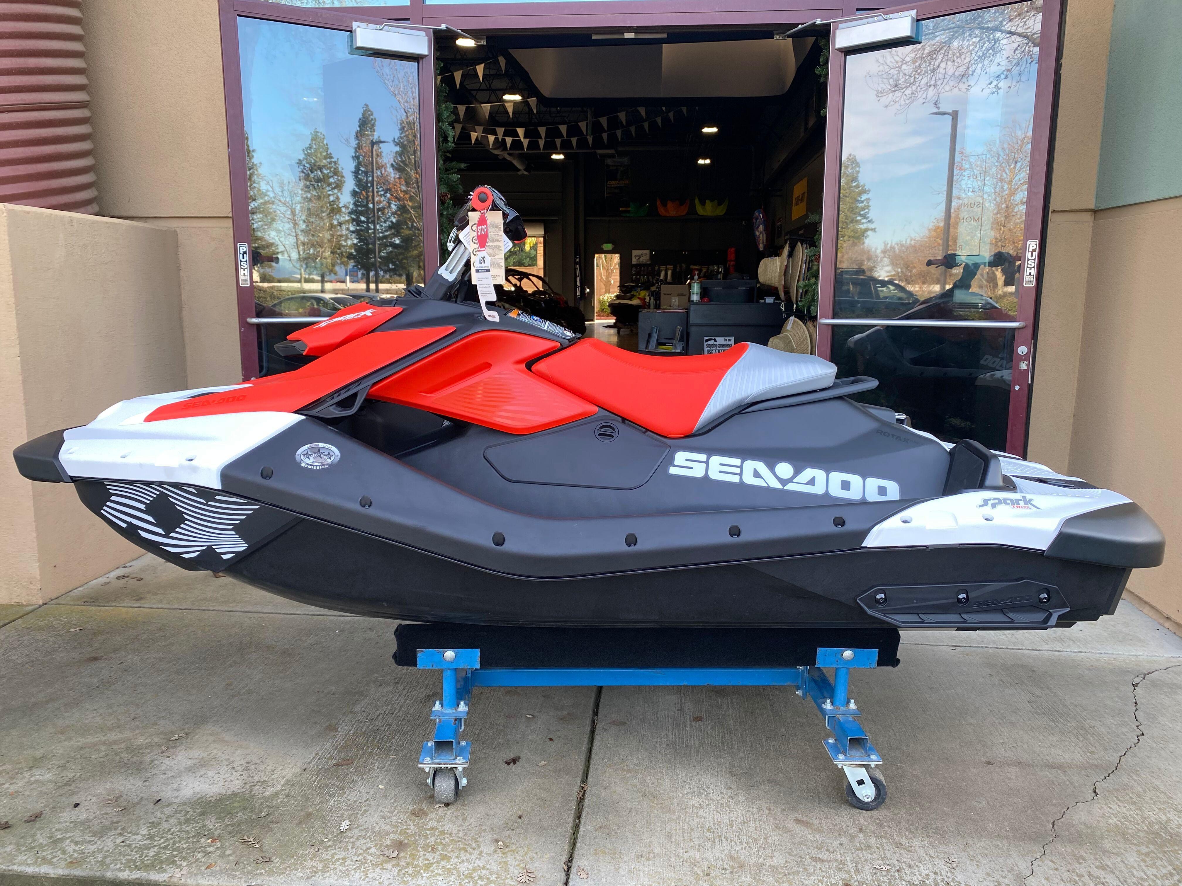 Sea-Doo Spark Trixx for 1 2024 Sea-Doo Spark Trixx for 1, red and black, displayed on a stand.