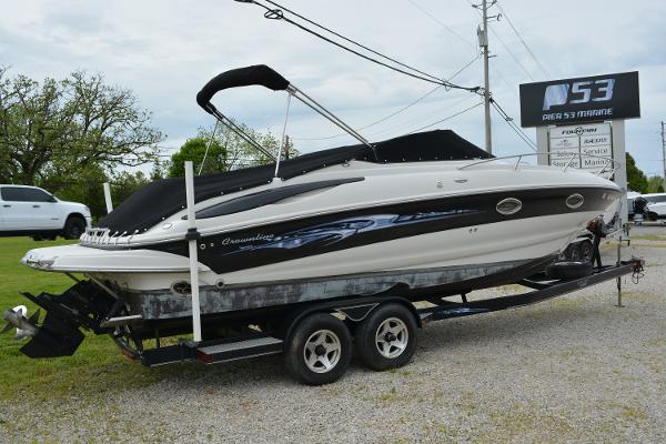 Crownline 275 CCR 2007 Crownline 275 CCR boat on trailer, parked outdoors near dealership sign.