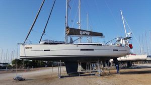 Dufour 500 Grand Large 2015 Dufour 500 Grand Large sailboat on dry dock, clear sky background.