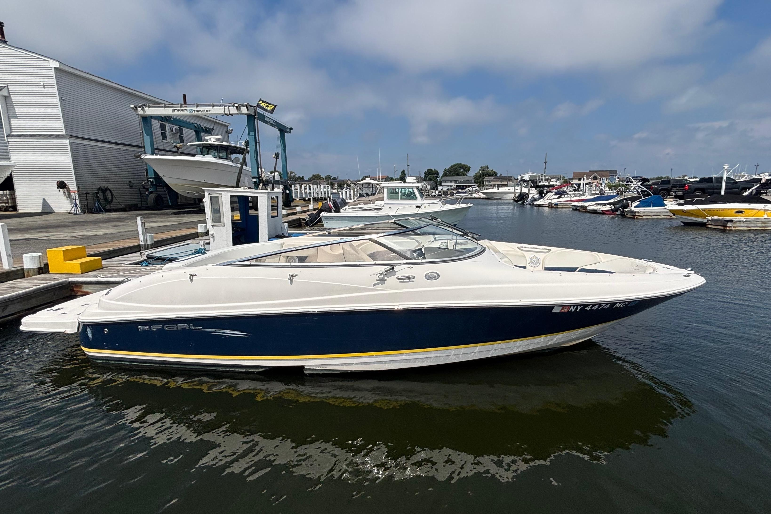Regal 2400 Bowrider 2007 Regal 2400 Bowrider boat docked at a marina under a clear sky.