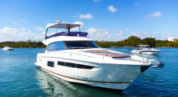 Prestige 560 Flybridge 2018 Prestige 560 Flybridge yacht cruising on a sunny day in clear blue waters.