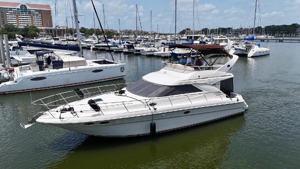 Sea Ray 400 Sedan Bridge 1997 Sea Ray 400 Sedan Bridge yacht docked in a marina, surrounded by other boats.