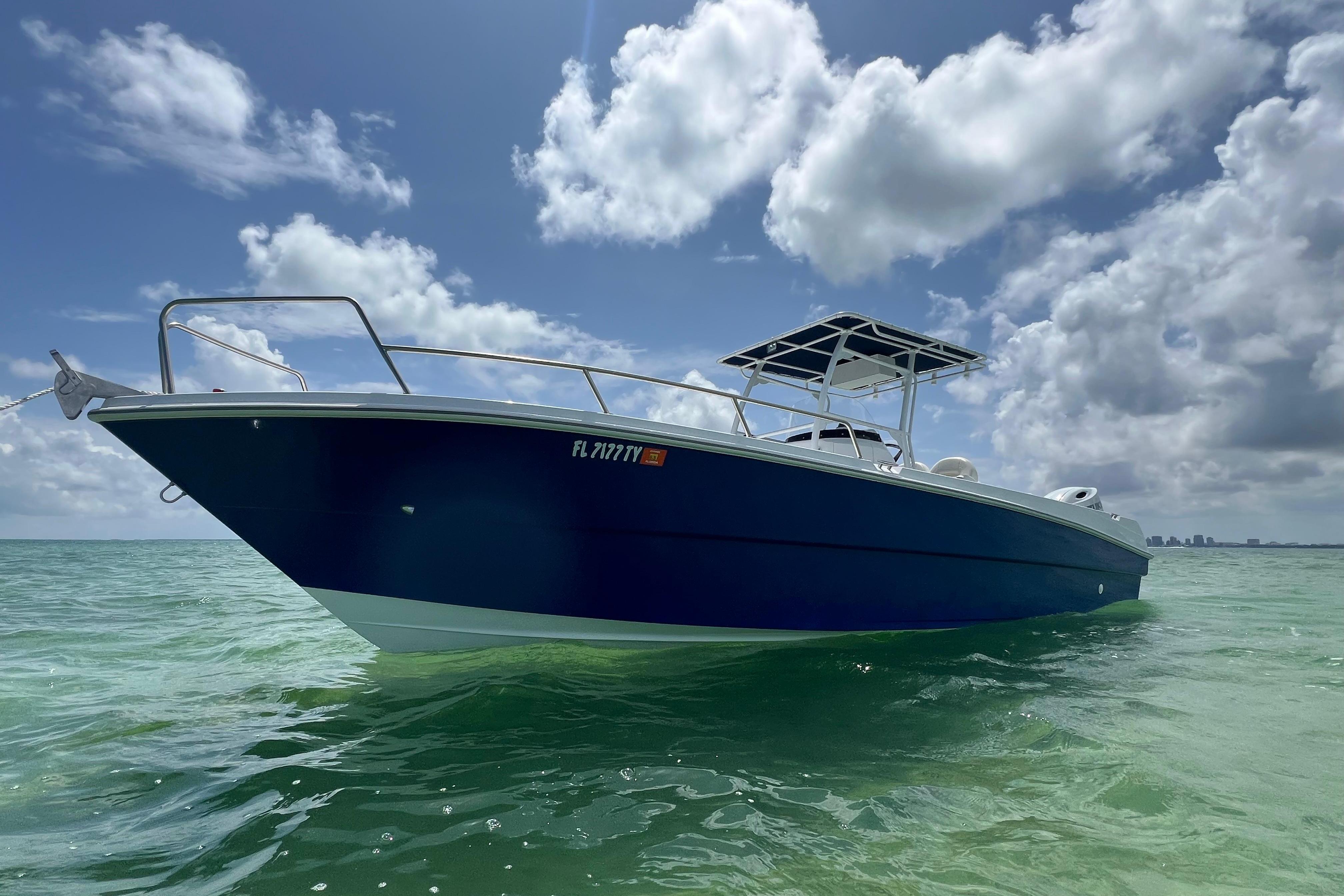 Custom Yamane 2024 Yamane Center Consoles boat on calm ocean under cloudy sky.