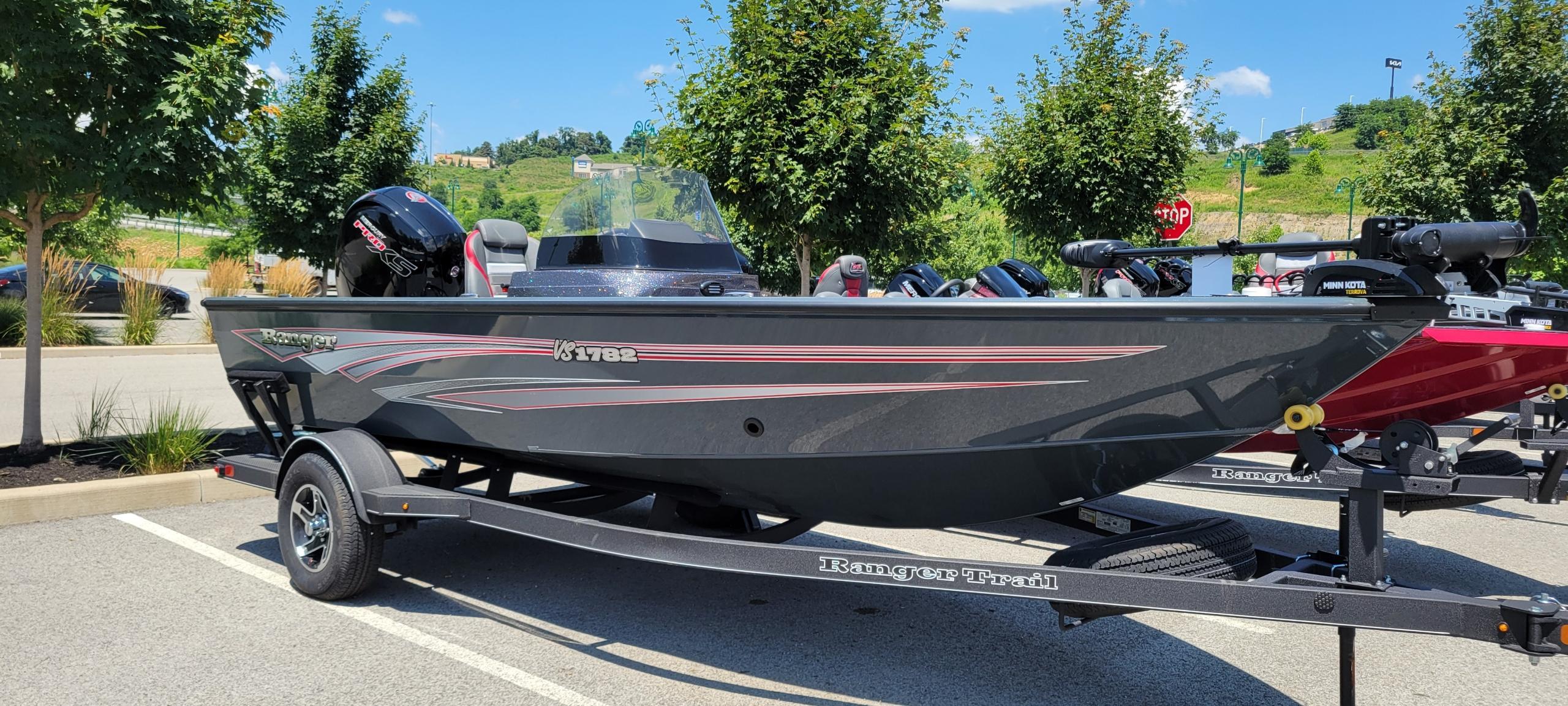 Ranger VS1782SC Angler 2024 Ranger VS1782SC Angler boat parked outdoors on a trailer, surrounded by trees.