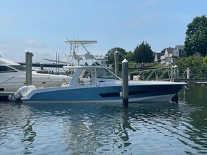 Boston Whaler 420 Outrage 2017 Boston Whaler 420 Outrage docked in a marina, surrounded by calm water.
