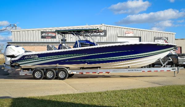 Nor-Tech 390 Sport 2020 Nor-Tech 390 Sport boat on trailer, parked outside a warehouse under blue sky.