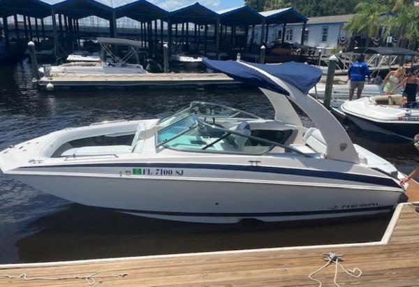 Regal 24 Fasdeck 2014 Regal 24 FasDeck boat docked at marina with blue canopy.
