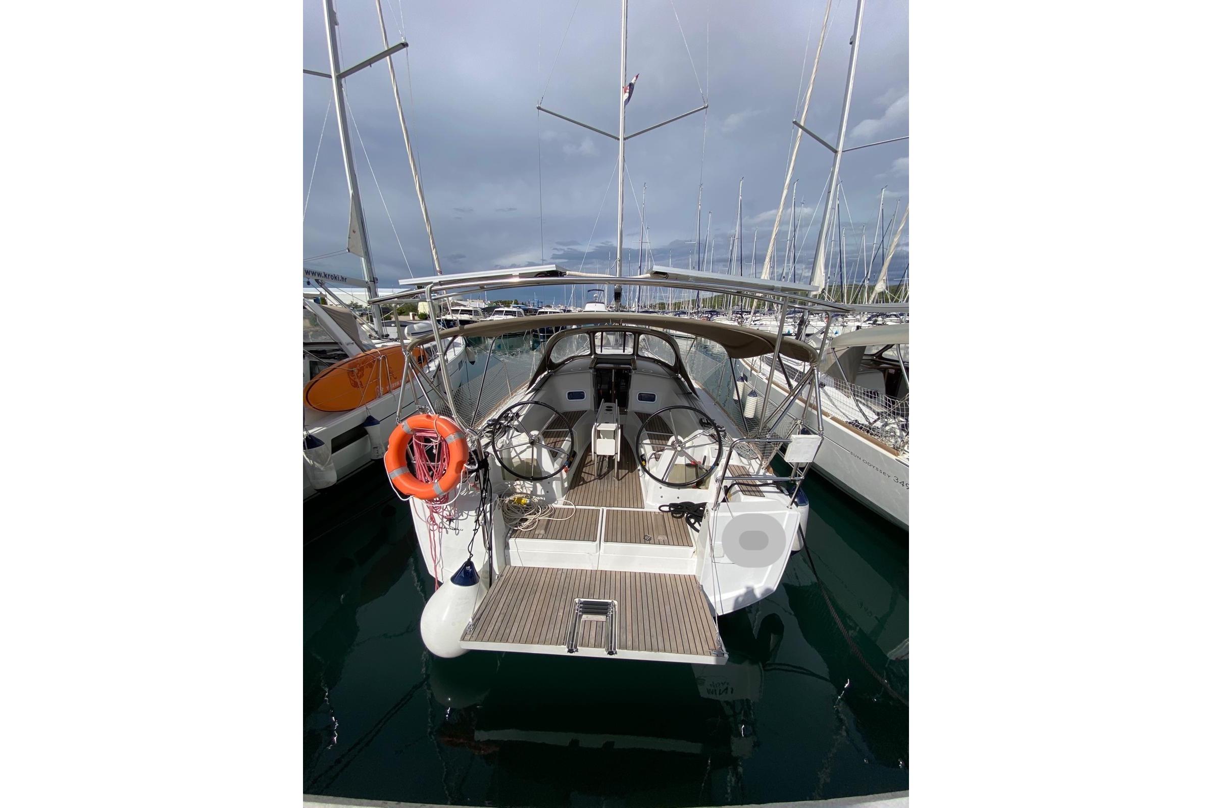 Jeanneau Sun Odyssey 349 2016 Jeanneau Sun Odyssey 349 sailboat docked in marina, rear view.