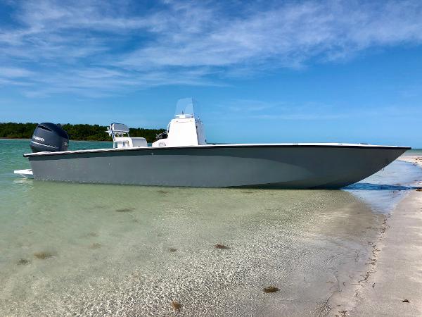 Rambo 27 Rambo 27 boat (2020) on a sandy beach with clear blue water and sky.