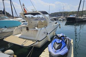 Gobbi 265 C 1998 Gobbi 265 C boat docked with a blue jet ski nearby in a marina.