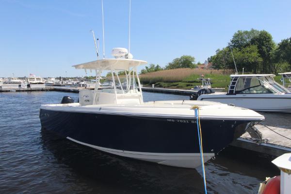 Sailfish 270 CC 2016 Sailfish 270 CC boat docked at marina, clear sky, calm water.