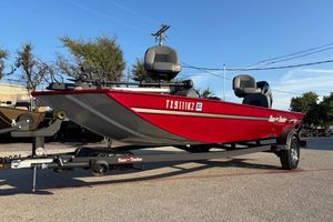Bass Tracker Classic XL 2024 Bass Tracker XL boat in vibrant red on a trailer, parked outdoors.