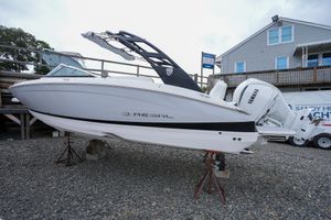Regal LX6 2026 Regal LX6 boat on display with Yamaha engine, parked on gravel.