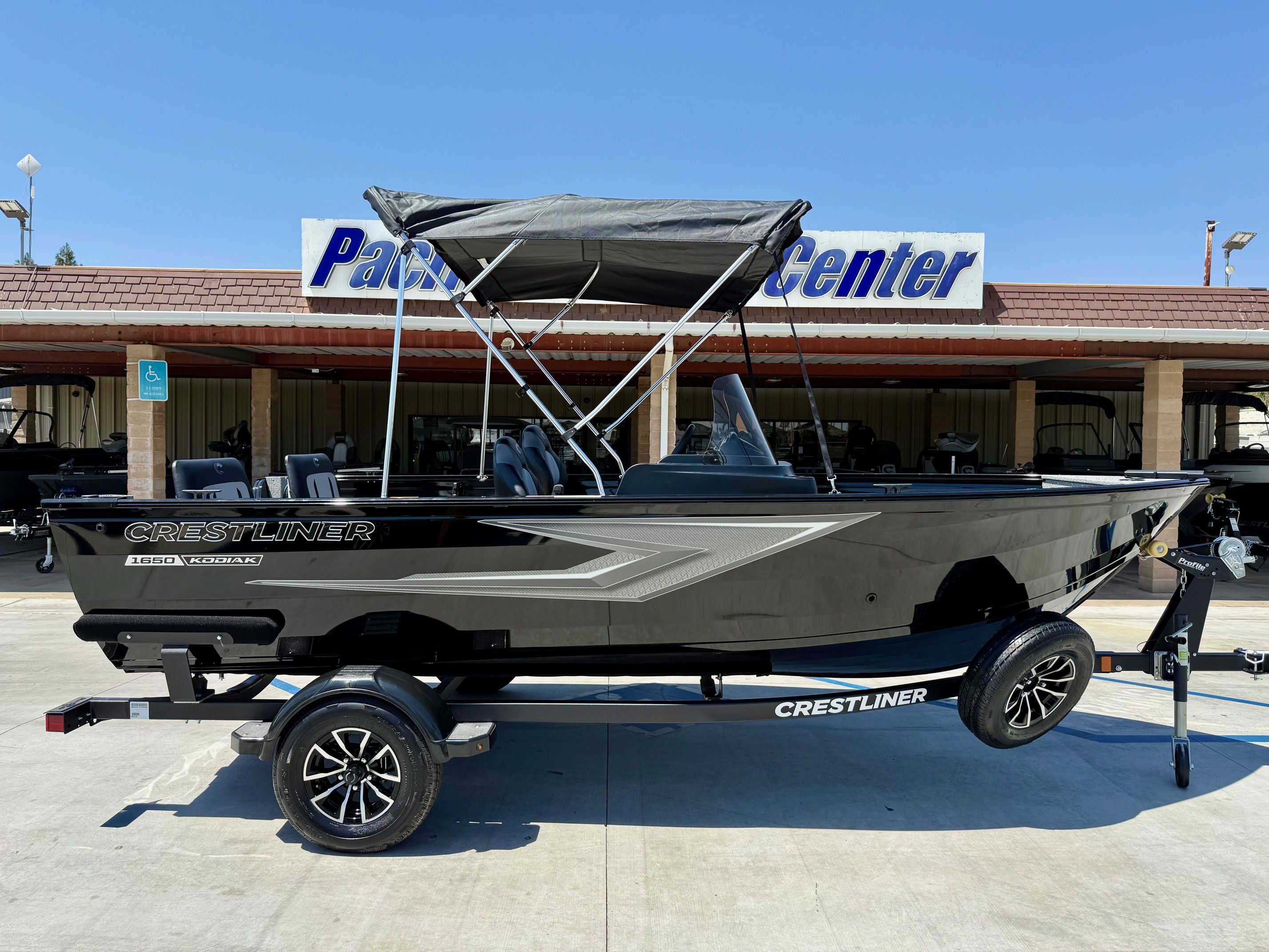Crestliner Kodiak 1650 SC w/ 60HP Mercury! 2025 Crestliner Kodiak 1650 SC boat with 60HP Mercury engine, parked at dealership.