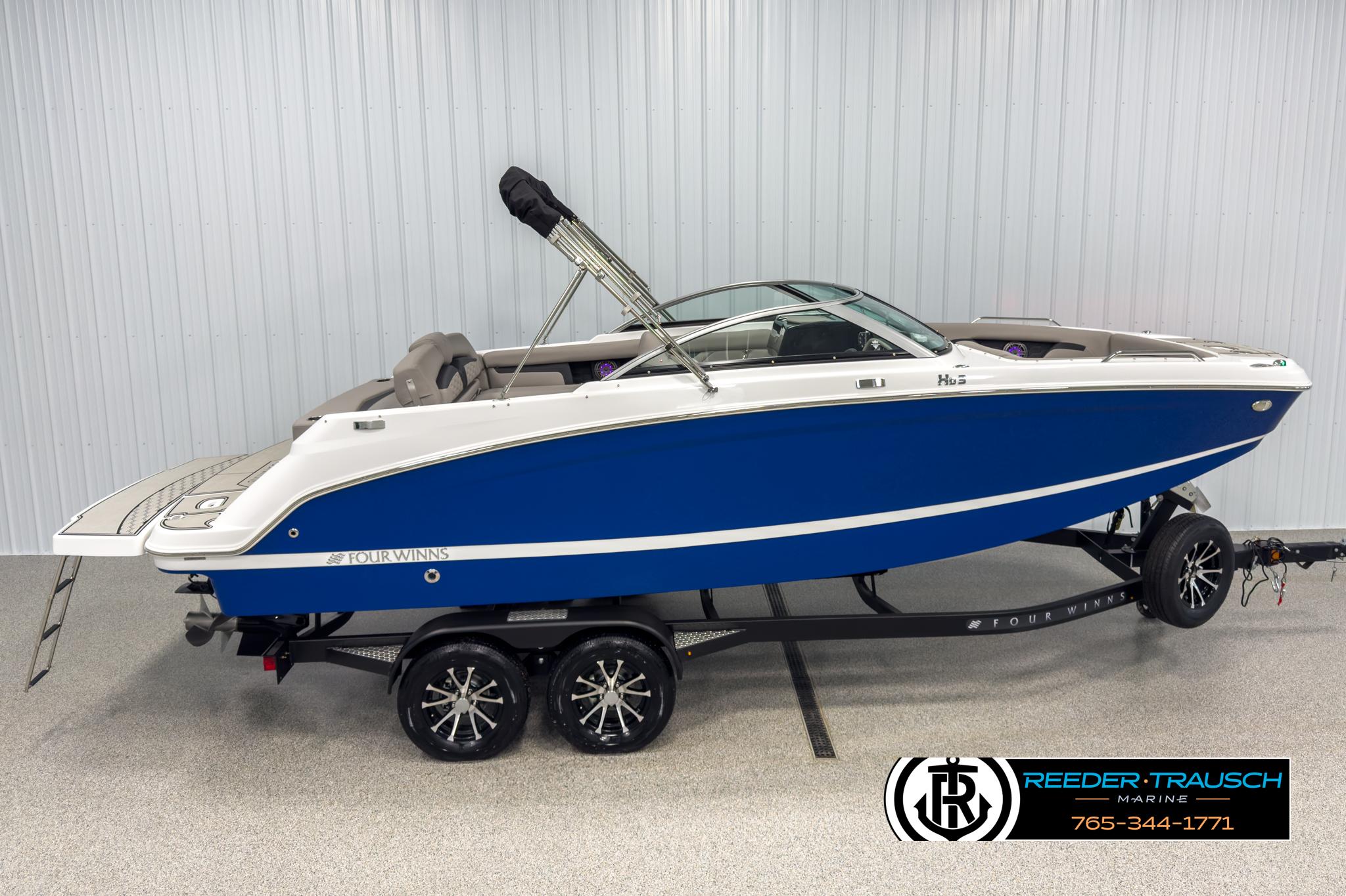 Four Winns HD3 2025 Four Winns HD3 boat in blue on trailer, displayed indoors.