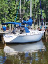 C&C 34 1982 C&C 34 sailboat docked in a serene marina setting.