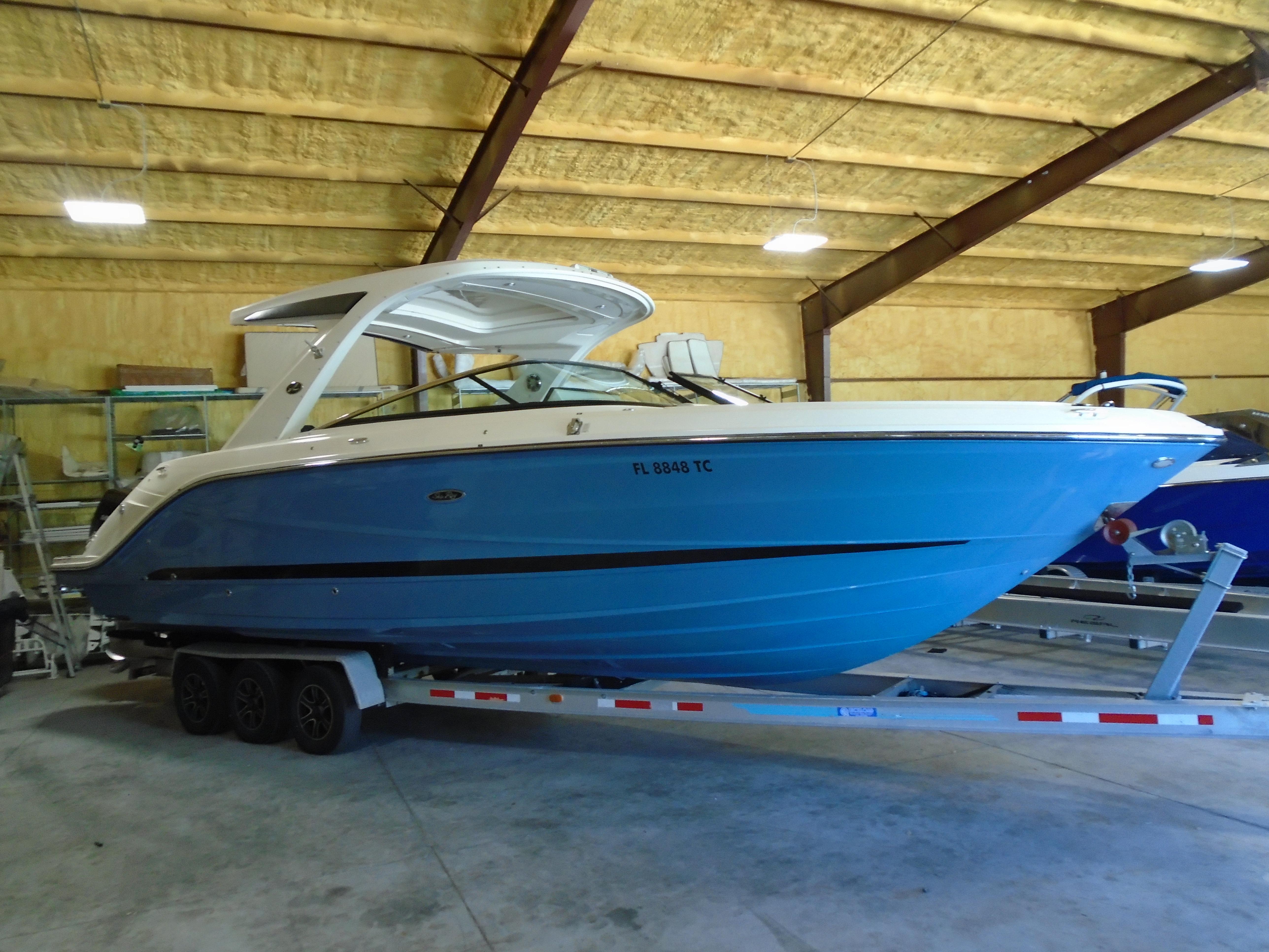 Sea Ray SLX 310 Outboard 2022 Sea Ray SLX 310 Outboard boat on trailer in indoor storage.