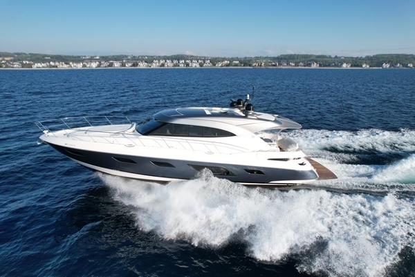 Riviera 6000 Sport Yacht 2023 Riviera 6000 Sport Yacht cruising on open water, showcasing sleek design and powerful performance.