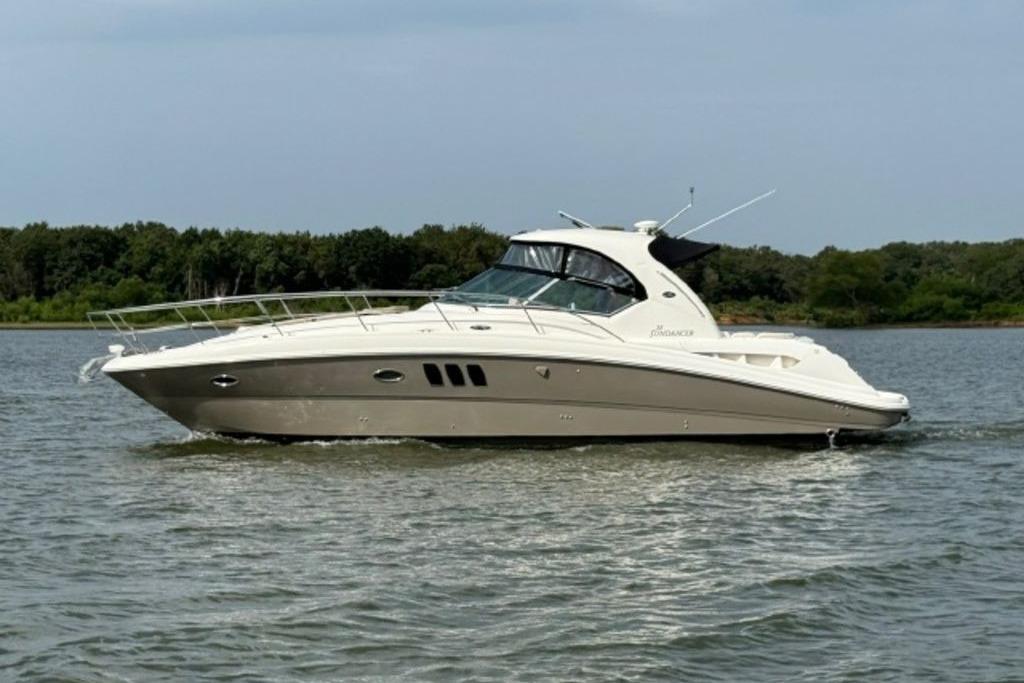 Sea Ray 38 Sundancer 2006 Sea Ray 38 Sundancer yacht cruising on a calm lake with forested shoreline.
