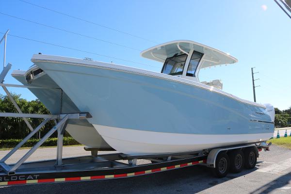 World Cat 280 CC 2025 World Cat 280CC boat on trailer, light blue hull, sunny day.