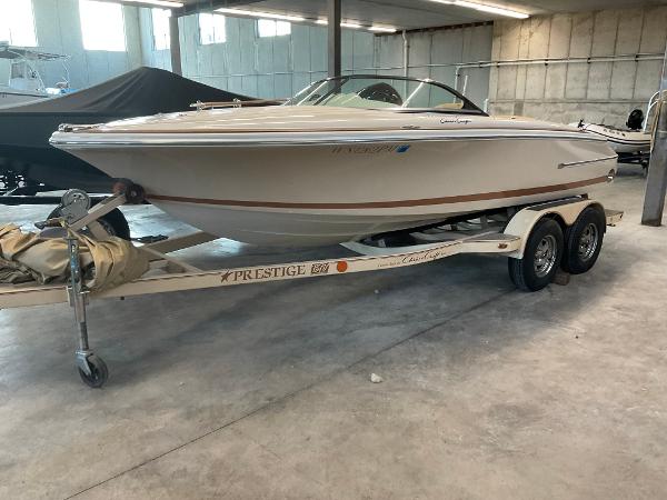 Chris-Craft Woody Speedster 2007 Chris-Craft Woody Speedster on trailer in a garage setting.